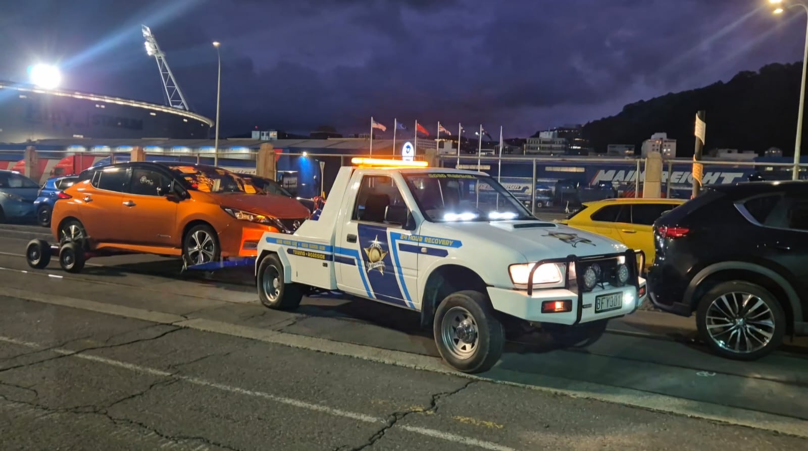 Road Marshall recovery truck loading an EV at night in Wellington
