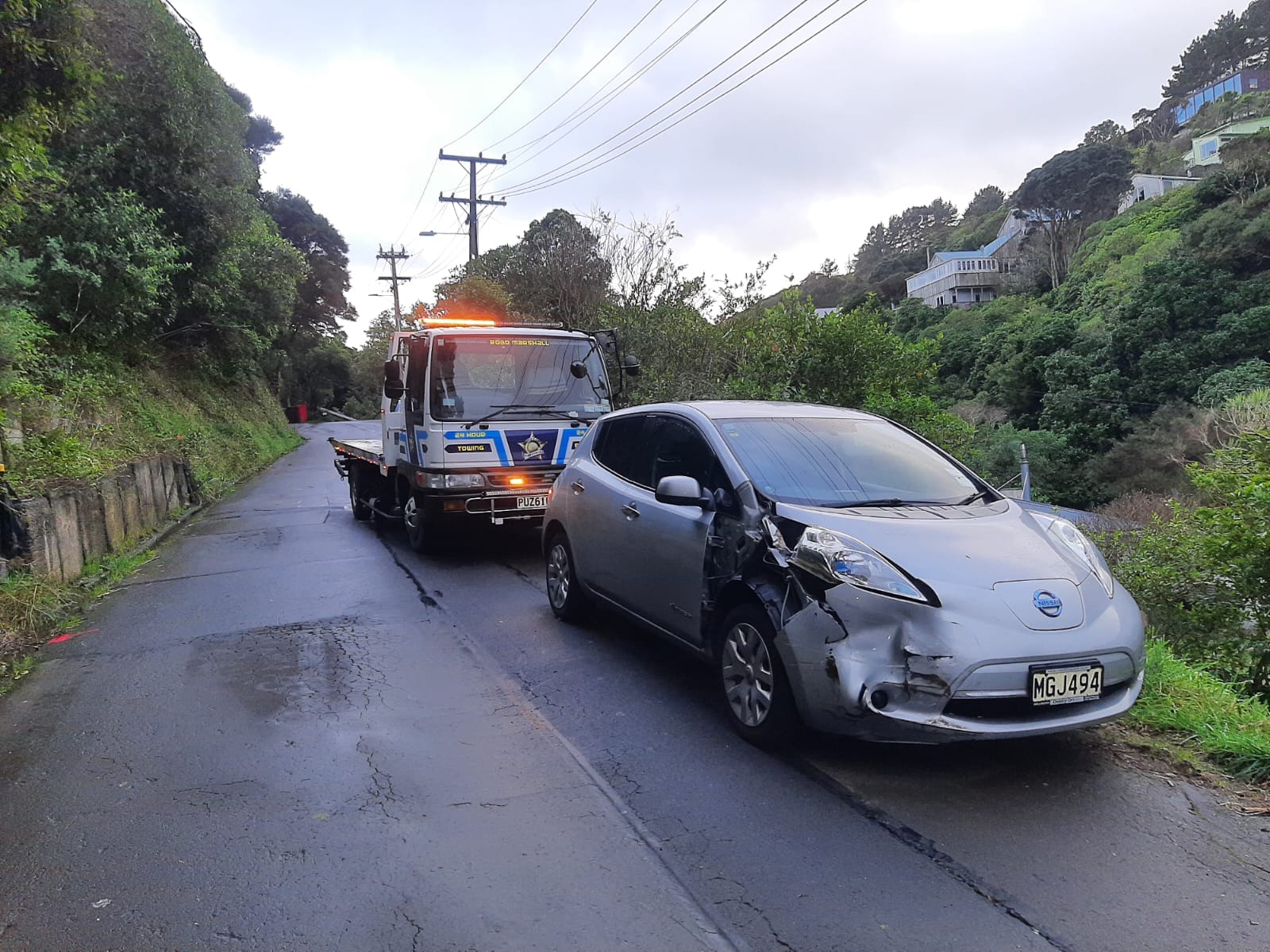 Road Marshall truck loading a damaged Honda Fit near a school