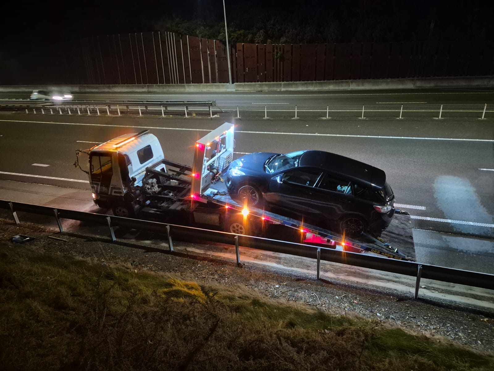 Road Marshall flatbed truck on a Wellington motorway at night